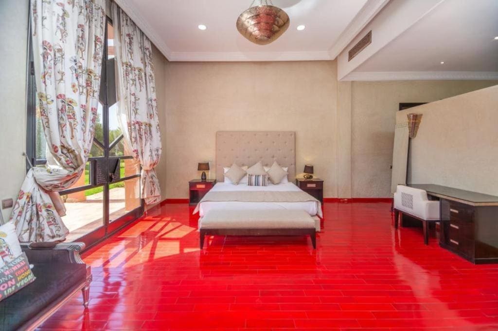 Stylish Moroccan bedroom with large king-size bed and pink accents